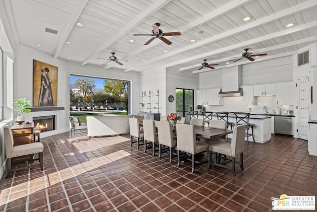 dining area with wood ceiling, beam ceiling, and dark tile patterned floors