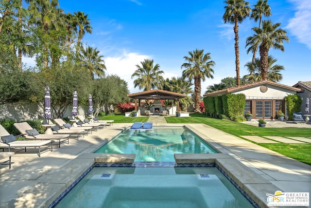 view of pool with a gazebo, an in ground hot tub, an outdoor structure, and a patio