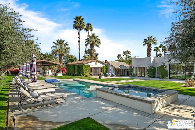 view of swimming pool with a yard, a gazebo, a patio, an outbuilding, and an in ground hot tub