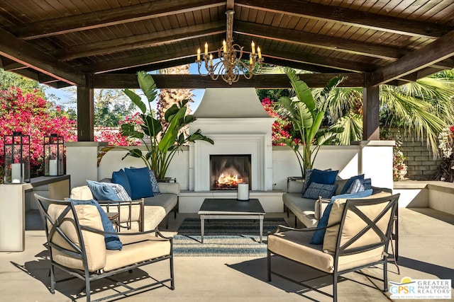 view of patio with an outdoor living space with a fireplace