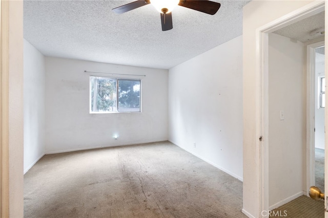 spare room featuring ceiling fan, a textured ceiling, and carpet flooring