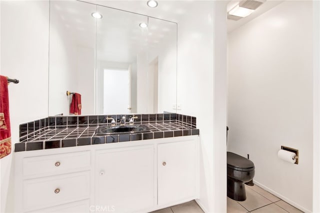 bathroom featuring tile patterned floors, toilet, and vanity