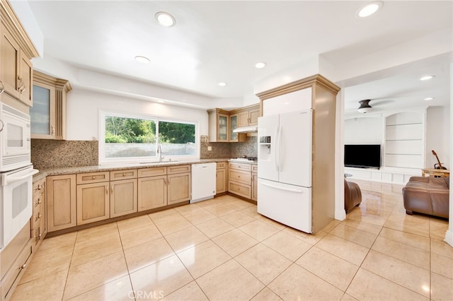 kitchen with white appliances, light brown cabinetry, sink, and light tile patterned floors