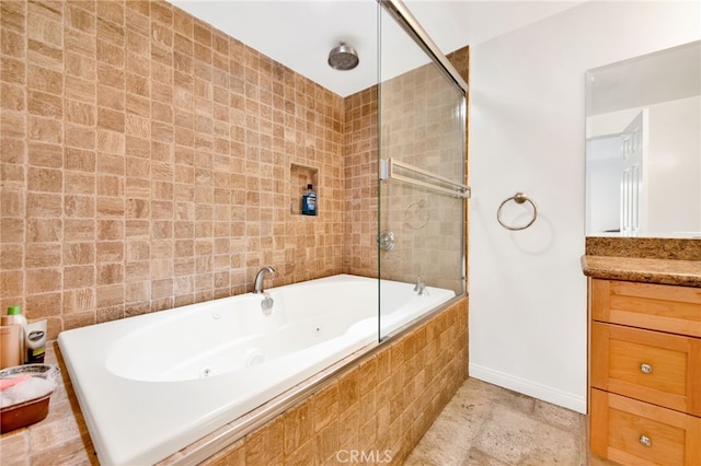 bathroom featuring tiled shower / bath combo and vanity