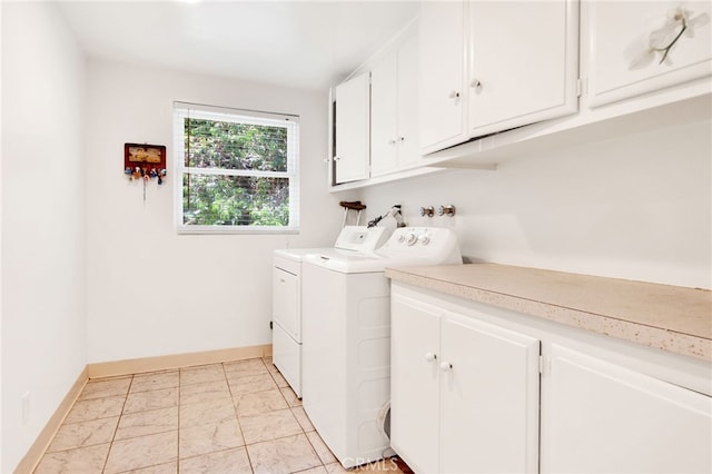 laundry room with independent washer and dryer and cabinets