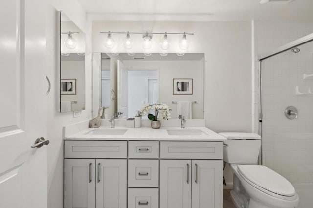 bathroom with vanity, toilet, and walk in shower