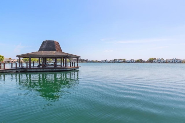 view of dock featuring a gazebo and a water view