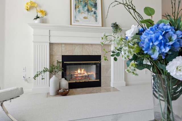 interior details featuring a tiled fireplace