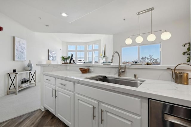 kitchen featuring pendant lighting, white cabinetry, sink, wine cooler, and light stone countertops