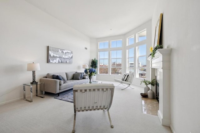 carpeted living room with a high ceiling