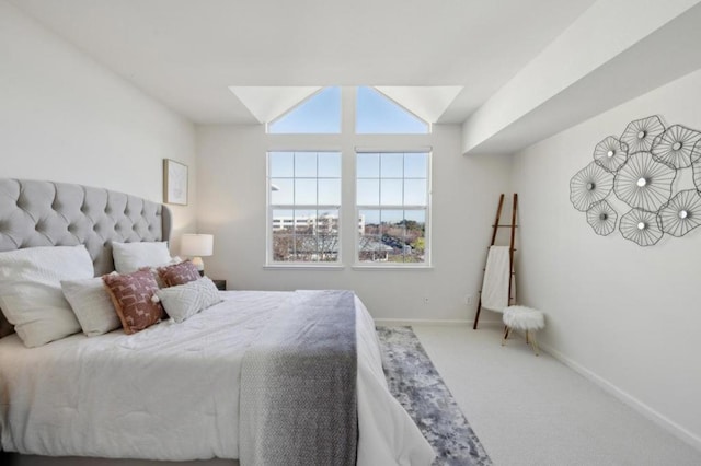 bedroom with vaulted ceiling and carpet floors