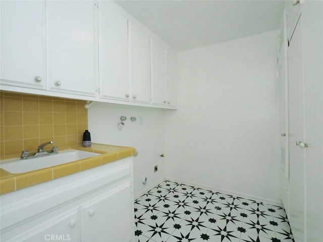 laundry room featuring sink, cabinets, and hookup for an electric dryer