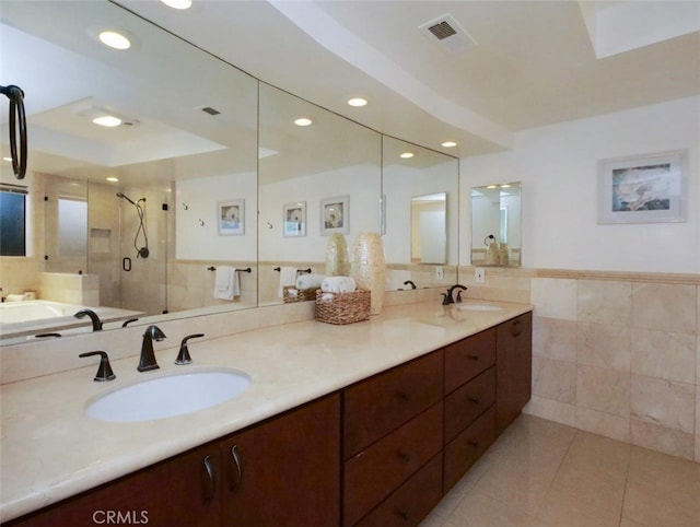 bathroom featuring tile walls, vanity, an enclosed shower, a raised ceiling, and tile patterned floors