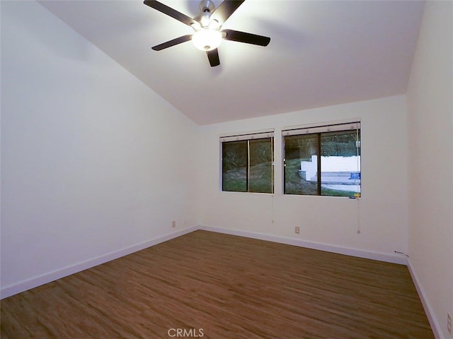 spare room featuring vaulted ceiling, ceiling fan, and dark hardwood / wood-style flooring