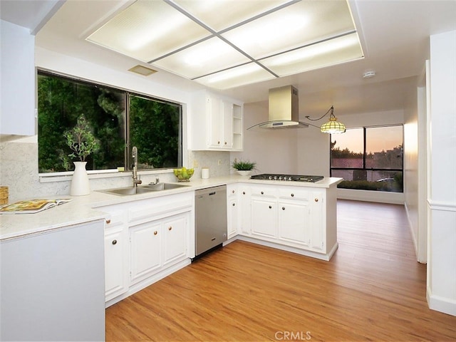 kitchen featuring island range hood, stainless steel appliances, kitchen peninsula, and white cabinets