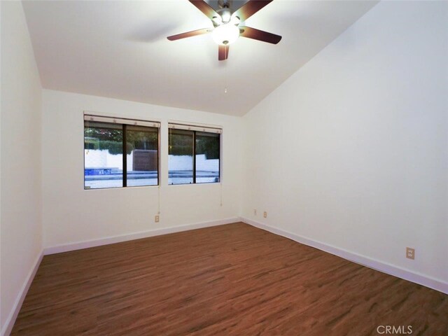 unfurnished room with lofted ceiling, dark hardwood / wood-style floors, and ceiling fan