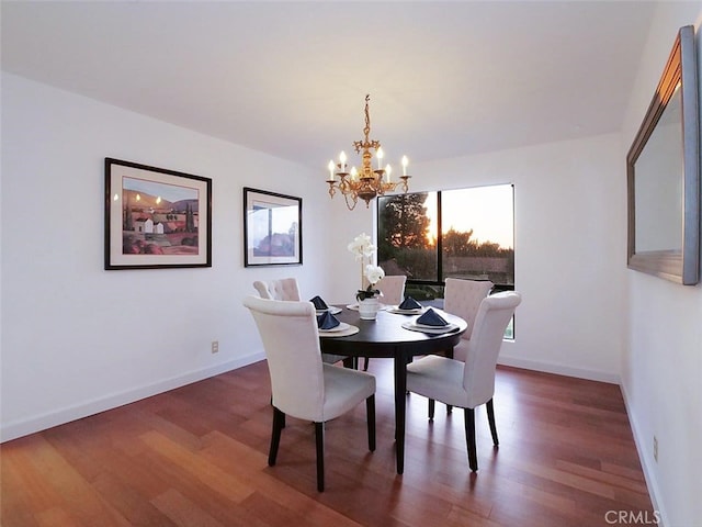 dining area featuring an inviting chandelier and dark hardwood / wood-style floors