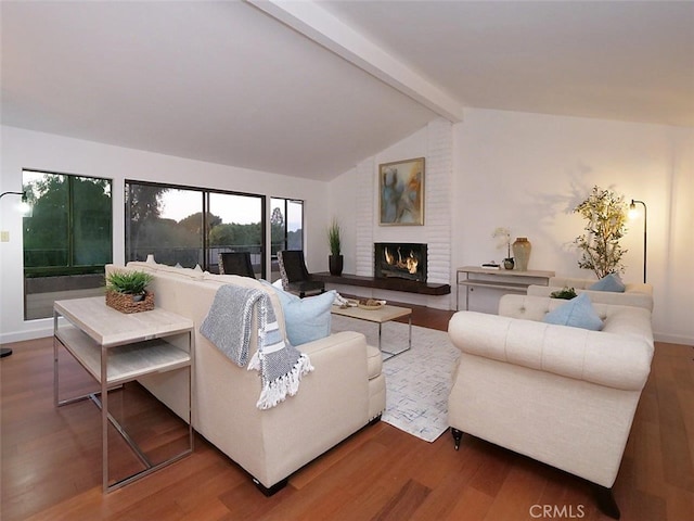 living room with a fireplace, lofted ceiling with beams, and hardwood / wood-style floors