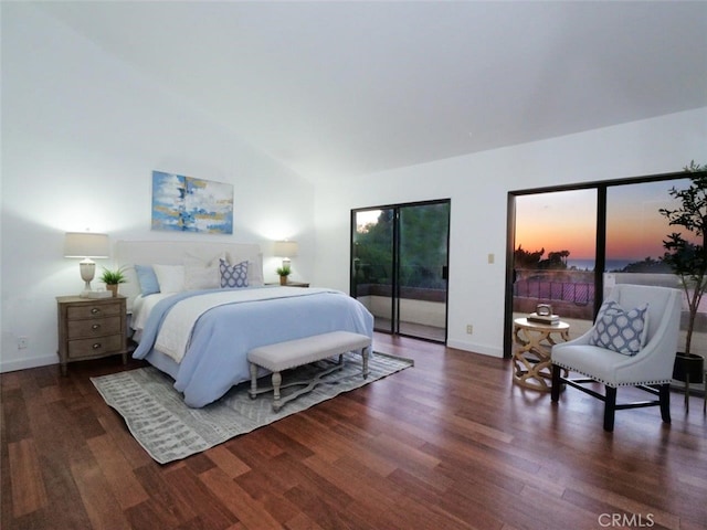 bedroom with multiple windows, lofted ceiling, dark hardwood / wood-style floors, and access to exterior