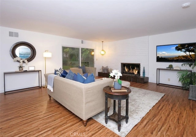 living room featuring hardwood / wood-style floors and a fireplace