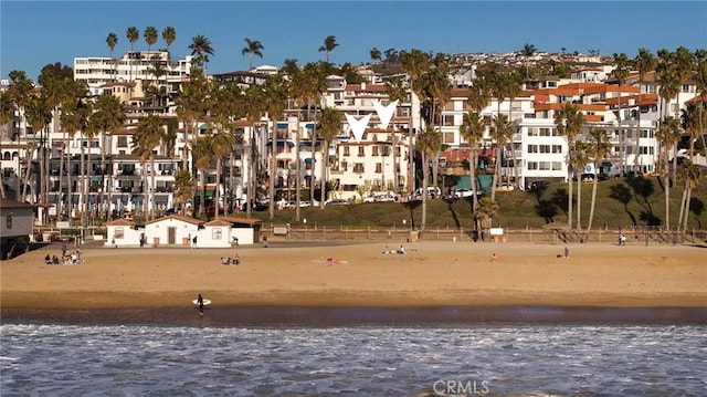 exterior space featuring a water view and a view of the beach