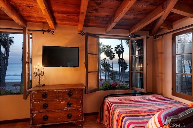 bedroom with wood-type flooring, beam ceiling, and wooden ceiling