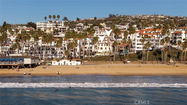 exterior space featuring a water view and a view of the beach