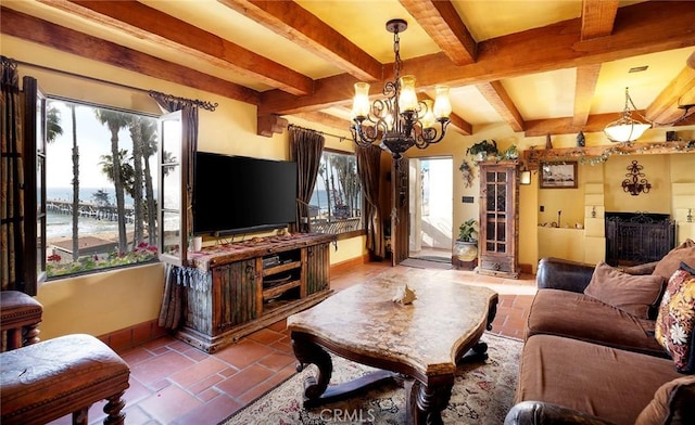 living area featuring baseboards, a chandelier, and beam ceiling