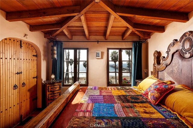 bedroom featuring multiple windows, wood ceiling, and beam ceiling