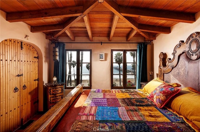 bedroom featuring wooden ceiling, multiple windows, and beamed ceiling