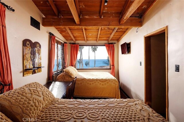 bedroom with lofted ceiling with beams and wood ceiling