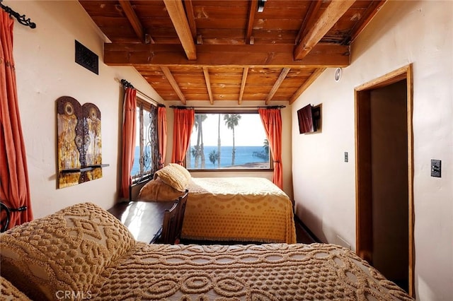 bedroom with vaulted ceiling with beams and wood ceiling