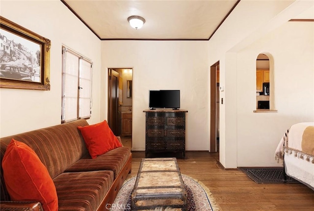 living room featuring ornamental molding and wood-type flooring