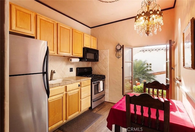 kitchen featuring crown molding, stainless steel appliances, tile counters, dark hardwood / wood-style flooring, and decorative light fixtures