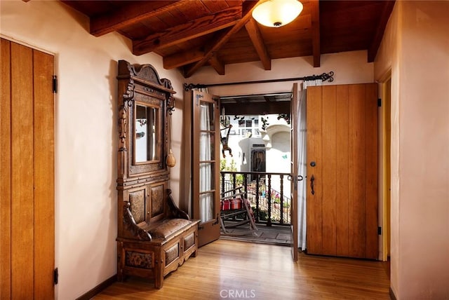 interior space featuring beamed ceiling, wood ceiling, and light hardwood / wood-style floors