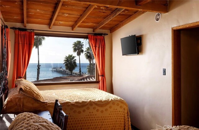 bedroom with vaulted ceiling with beams and wood ceiling