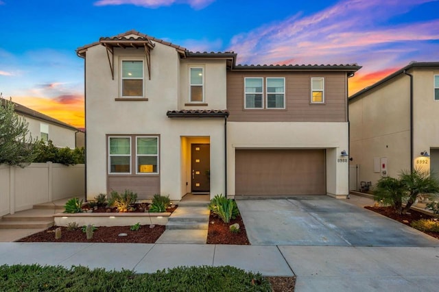 mediterranean / spanish-style home with a garage