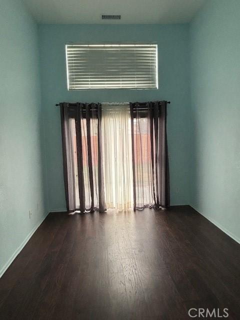 unfurnished room featuring dark hardwood / wood-style floors