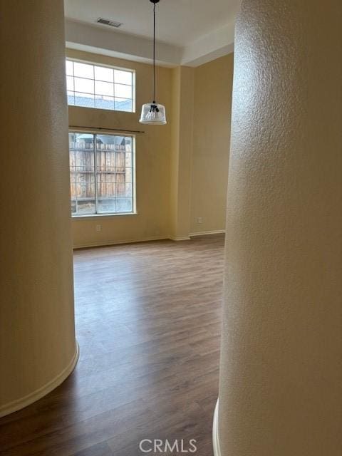 unfurnished dining area with wood-type flooring