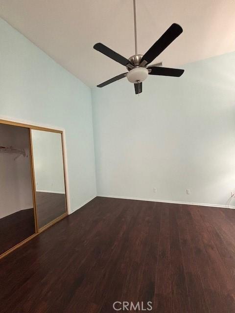 unfurnished bedroom featuring lofted ceiling, ceiling fan, and wood-type flooring