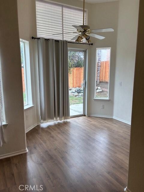 empty room featuring ceiling fan and dark hardwood / wood-style flooring