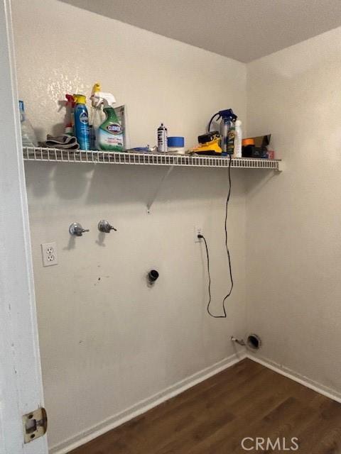 laundry room featuring hookup for a washing machine, electric dryer hookup, and dark wood-type flooring