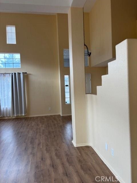 unfurnished room featuring dark wood-type flooring