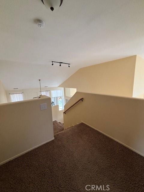 interior space featuring lofted ceiling and carpet floors