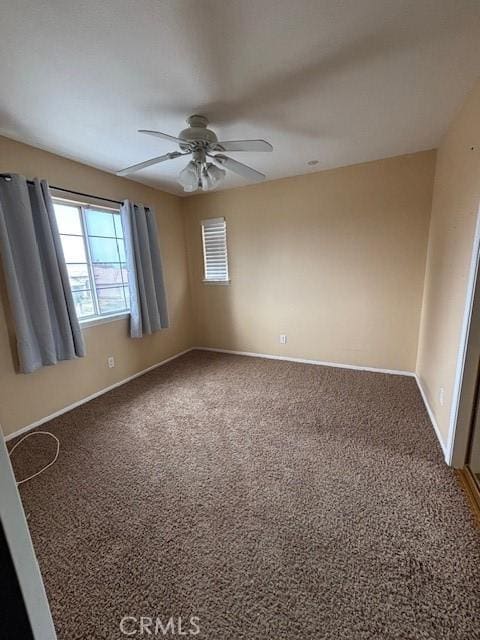 unfurnished room with ceiling fan and carpet flooring