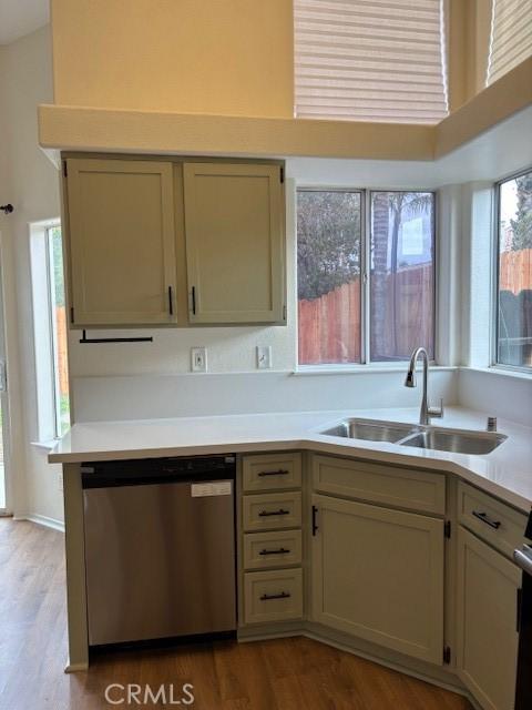 kitchen featuring sink, stainless steel dishwasher, range, and light hardwood / wood-style flooring