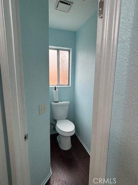 bathroom with wood-type flooring and toilet