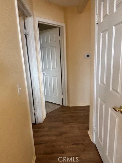 corridor with dark hardwood / wood-style floors