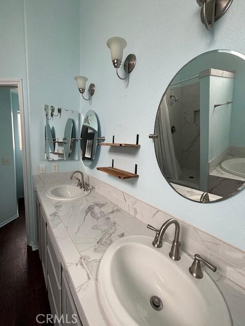 bathroom featuring vanity, shower with separate bathtub, and hardwood / wood-style floors