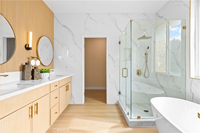 bathroom featuring vanity, wood-type flooring, and shower with separate bathtub